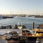 Food and wine set beside the harbor in Punta del Este