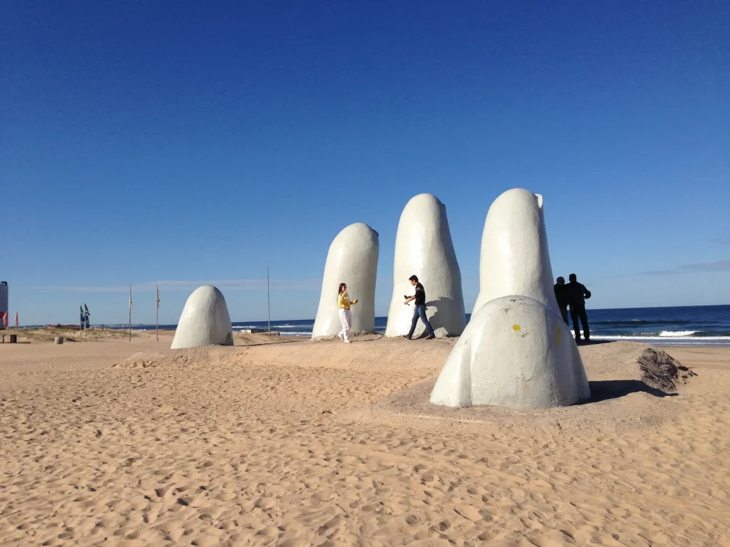 La Mano sculpture rising from the sand at Playa Brava