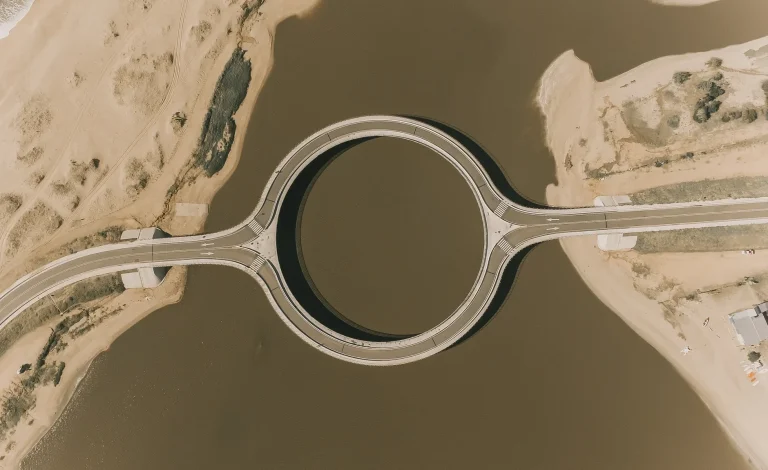Aerial view of the circular Laguna Garzón Bridge crossing the lagoon in Uruguay.