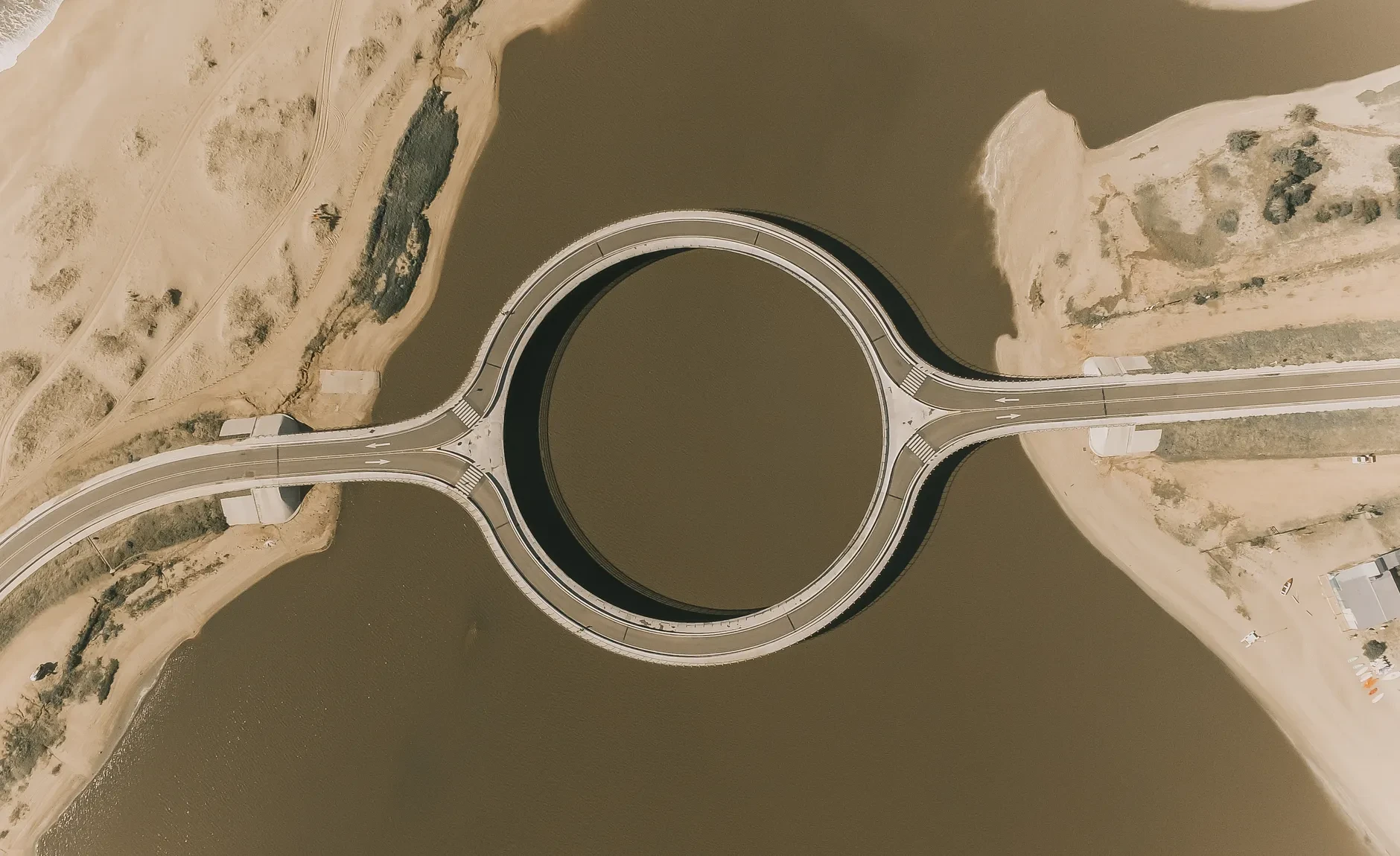 Aerial view of the circular Laguna Garzón Bridge crossing the lagoon in Uruguay.